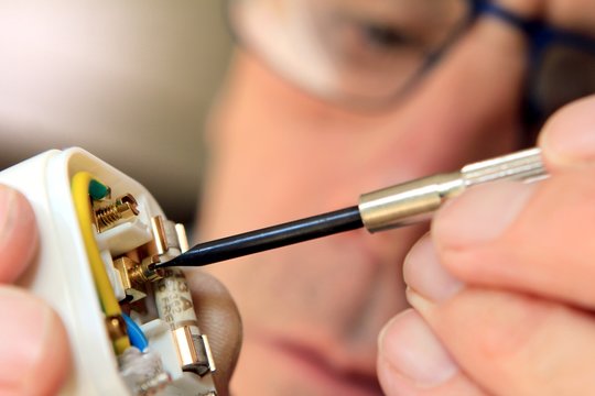 Man Rewiring Plug Socket