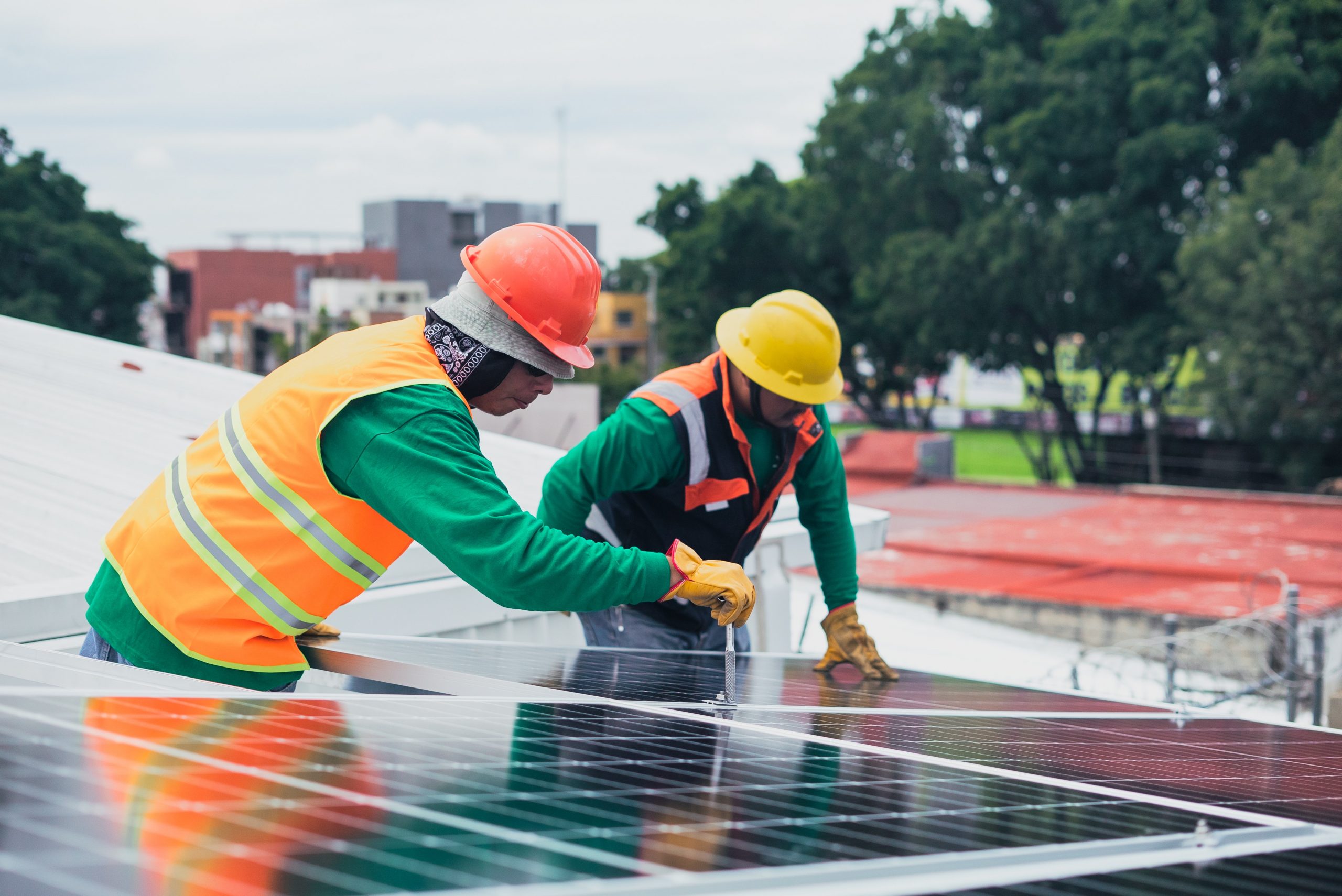 contractors installing solar panels on a business